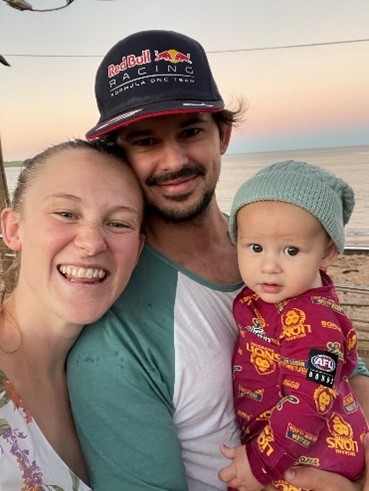 Ryan Caetano with his wife and child